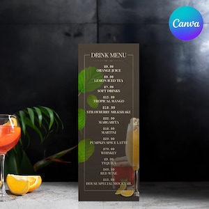 May include: A brown menu board with a drink menu listing prices for orange juice, lemon iced tea, soft drinks, tropical mango, strawberry milkshake, margarita, martini, pumpkin spice latte, whiskey, tequila, red wine, and a house special mocktail. The menu is decorated with green leaves.