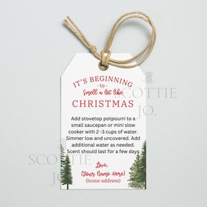 May include: White gift tag with a red and green Christmas theme. It says "It's beginning to smell a lot like Christmas".  Instructions for making a Christmas potpourri are included.  The tag is decorated with two green pine trees.