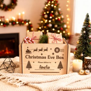 May include: A wooden Christmas Eve Box, decorated with a sleigh and reindeer, containing wrapped gifts, candy canes, and greenery. The box is inscribed with "Christmas Eve Box" and "Please deliver to: Amelia".