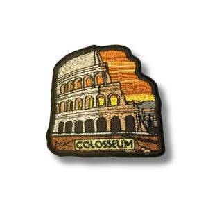 May include: Embroidered patch depicting the Colosseum in Rome, Italy, set against a sunset. The patch has a black border and the word "COLOSSEUM" embroidered at the bottom. The design features shades of brown, beige, orange, and yellow.