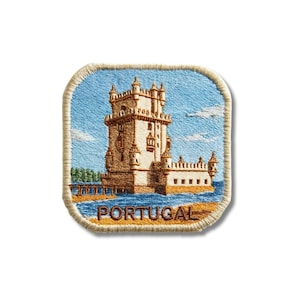 May include: A square embroidered patch with rounded corners featuring a detailed depiction of the Belém Tower in Portugal. The design includes a light blue sky, tan stone architecture, blue water, and the word PORTUGAL stitched in brown thread.