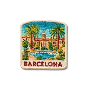 May include: A square embroidered patch featuring a colorful scene of Barcelona with a central fountain, palm trees, and a building with a dome. The word BARCELONA is stitched in red capital letters at the bottom against a cream-colored background.