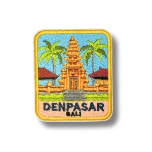 May include: Embroidered patch featuring a golden Balinese temple with palm trees against a blue sky. The patch has a yellow border and the text "DENPASAR BALI" in white letters.