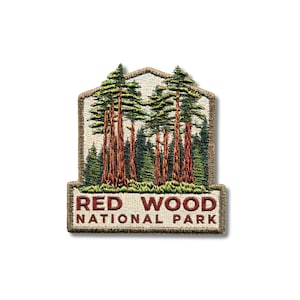 May include: An embroidered patch featuring a forest of tall redwood trees with reddish-brown trunks and green needles against a cream background. The text RED WOOD NATIONAL PARK is stitched in dark red letters at the bottom of the patch.
