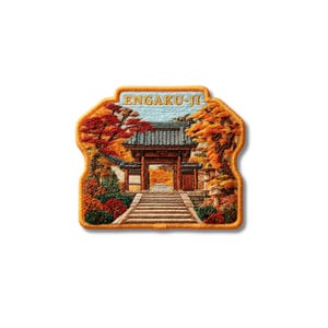 May include: A rectangular embroidered patch with rounded corners featuring a detailed scene of the Engaku-ji temple gate. The design includes a stone staircase, autumn foliage in shades of red and orange, and the text ENGAKU-JI in light blue.