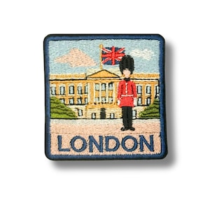 May include: Embroidered patch featuring a London scene. The design includes a building, a British flag, and a royal guard. The word "LONDON" is embroidered at the bottom. The patch has a blue border.