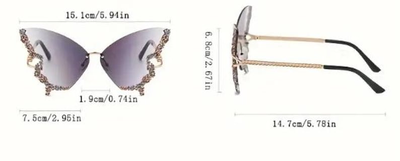 May include: Butterfly-shaped sunglasses with a gradient lens. The frame is gold-colored with decorative embellishments on the outer edges. The sunglasses measure 5.94 inches wide, 2.95 inches high, and 5.78 inches long.