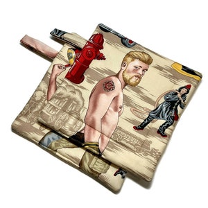 May include: Two beige pot holders with a firefighter theme. One pot holder features a man with a beard and a tattoo, holding a red fire hydrant. The other pot holder features a firefighter holding a hose. Both pot holders have a beige background with a pattern of fire engines and hoses.