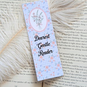 May include: A rectangular bookmark with a light blue gingham pattern and small pink flowers. An oval in the center features a bouquet of flowers. The text "Dearest Gentle Reader" is displayed in elegant script.