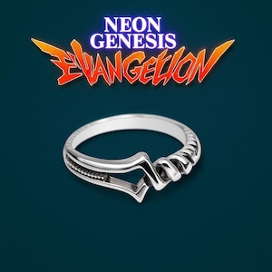 May include: A silver ring with a unique design, featuring a stylized shape and a twisted element. The ring is set against a dark teal background, with the "Neon Genesis Evangelion" logo in the upper portion of the image.
