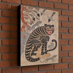 May include: A canvas print featuring a traditional Asian tiger illustration. The tiger is depicted with black stripes and orange accents, surrounded by other animals and a tree. The artwork has a vintage aesthetic.