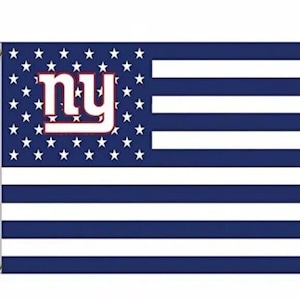 May include: A blue and white American flag with the New York Giants logo in the center. The logo is white with red outlines and the letters "NY" in a stylized font.