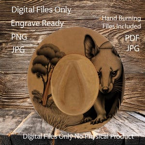 May include: A tan-colored hat with a detailed illustration of a fox and a tree. The hat is designed for engraving and includes hand-burning files. The image also includes the text "Digital Files Only" and "Engrave Ready".