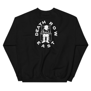 Könnte beinhalten: Schwarzes Sweatshirt mit weißer Grafik auf dem Rücken. Die Grafik zeigt eine Person in einem elektrischen Stuhl, umgeben von den Worten "DEATH ROW EAST" in kreisförmiger Anordnung.