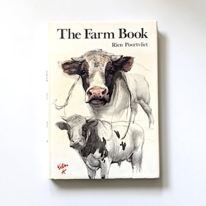 May include: A vintage book titled "The Farm Book" by Rien Poortvliet. The cover features a detailed illustration of two cows in black, white, and gray tones. The book has a cream-colored background and the title is in bold black font.