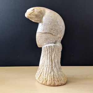 Vintage carved stone parrot figurine.