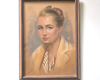 May include: A framed portrait of a woman in a light-colored jacket and patterned scarf. The artwork is a pastel drawing with soft colors and a brown wooden frame. The woman has light skin, blue eyes, and her hair is styled up.