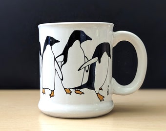 1980s ceramic coffee mug with penguins.