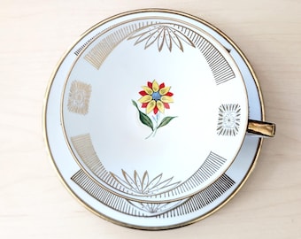 Tazza e piattino Winterling Roslau Bavaria, porcellana tedesca di metà secolo, finiture dorate, decorazione floreale centrale.