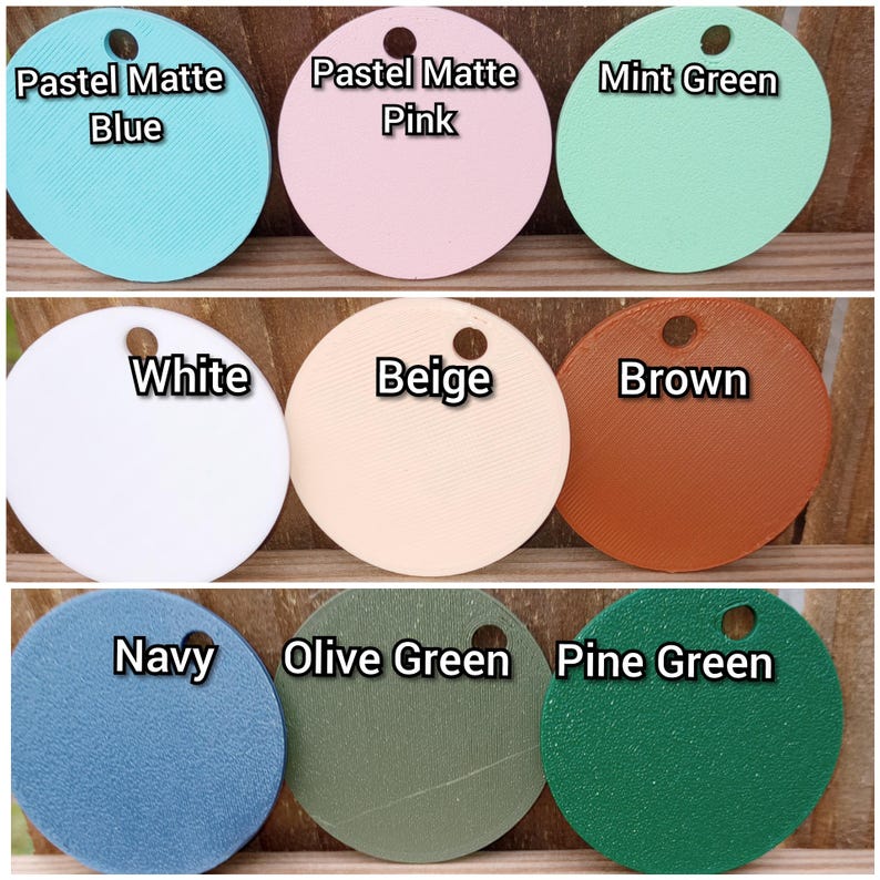 May include: Nine round paint chips in various colors, including pastel blue, pastel pink, mint green, white, beige, brown, navy, olive green, and pine green. The paint chips are arranged in three rows of three.