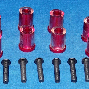 May include: Set of eight red and clear plastic bushings with ten black screws. The bushings are cylindrical and have a red rim. The screws are approximately 2 inches long.