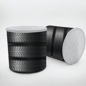 May include: Two black and white cylindrical containers with a tire tread pattern. The containers have white lids.