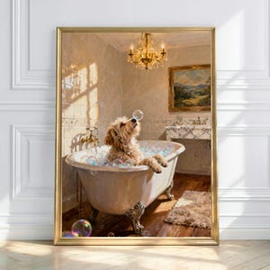 May include: A framed print depicts a dog in a claw-foot bathtub filled with bubbles. The dog, with light brown fur, is looking up at a bubble. The bathroom has a chandelier, a painting, and a marble sink. The frame is gold.