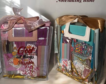 May include: Two clear tote bags filled with Bible study supplies, including a notetaking Bible, stickers, and notepads. The bags are tied with ribbons and include the text "God all things Possible".