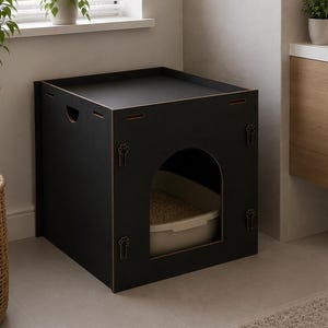 May include: A matte black square pet enclosure featuring a flat top surface and an arched front opening. Inside the enclosure, a light beige plastic litter tray is visible. The structure is constructed from flat panels with small paw print cutouts.