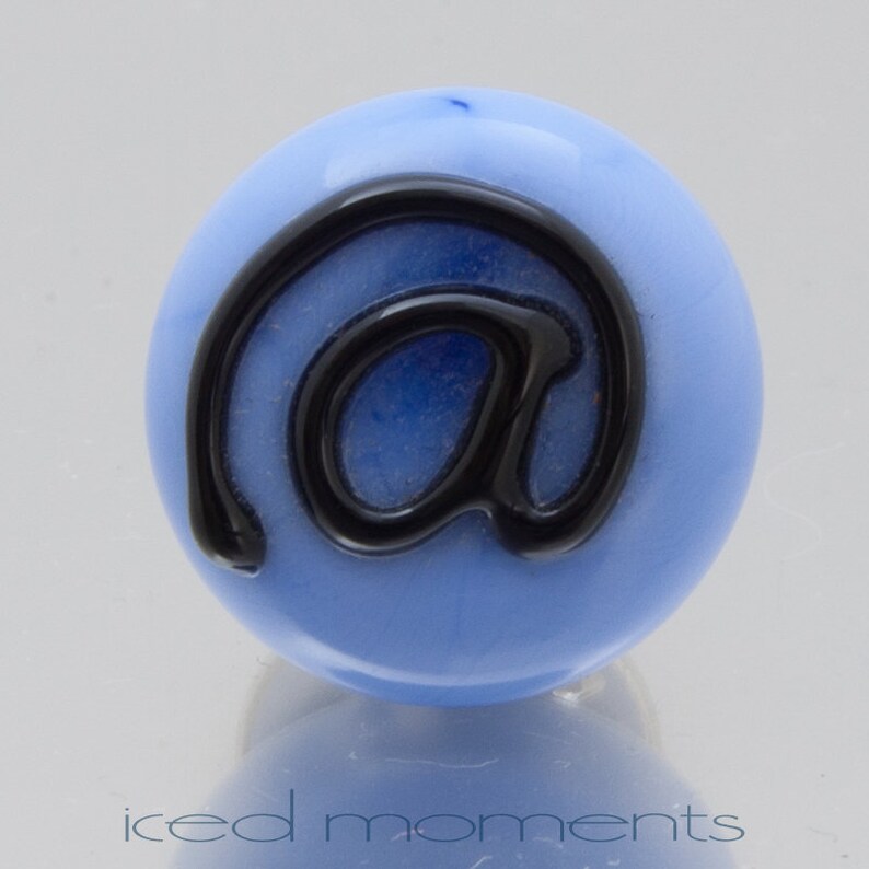 Lampwork glass by Jennie Yip At sign @ in light blue and black Lapel pin