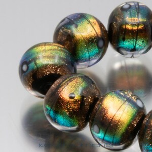 Lampwork bead set: Comet trails in salmon pink dichroic. Lampwork by Jennie Yip