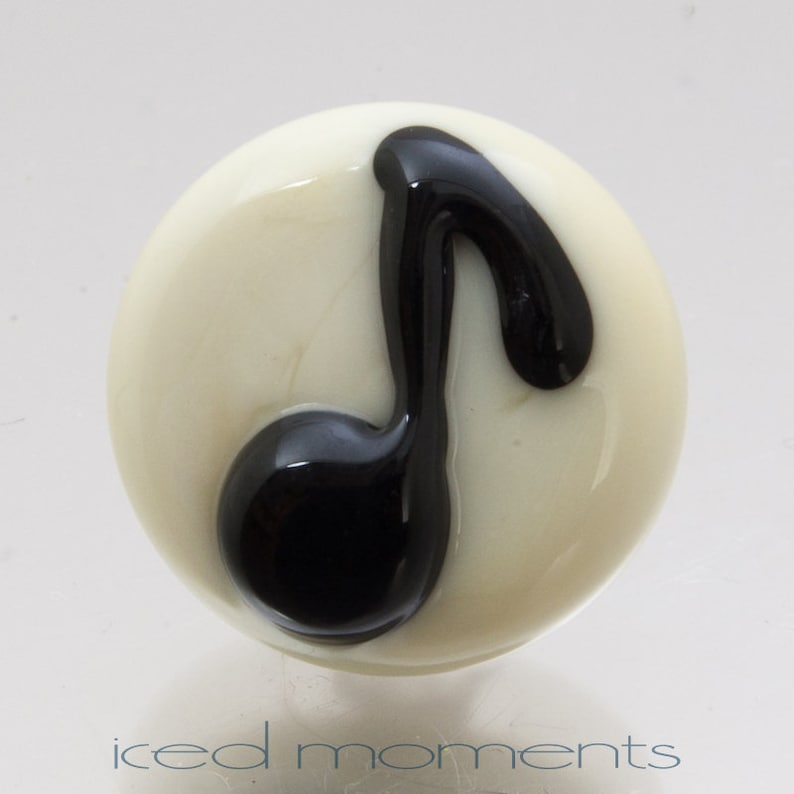 Lampwork glass by Jennie Yip At sign @ in light blue and black Lapel pin