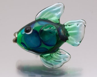 Fish in green, glass lapel pin. Lampwork glass art by Jennie Yip