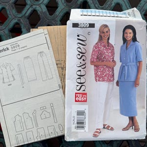 May include: A See & Sew 3809 sewing pattern envelope featuring illustrations of a button-down shirt, pants, and a skirt. The envelope displays two outfits: a pink floral shirt with white pants and a solid light blue shirt with a matching skirt.