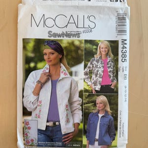 May include: McCall's sewing pattern envelope featuring a woman in a white jacket with floral embroidery. The envelope includes images of the finished garments, with the text "Sew News" and "Machine Embroidery Design". The item number is 43851.