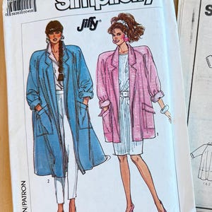 May include: A Simplicity Jiffy sewing pattern envelope, number 7898, size MD (14-16). The front features illustrations of two outfits: a long blue coat over white trousers and a pink jacket over a white dress, both with large patch pockets.