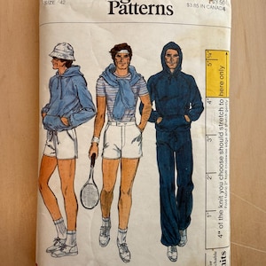 May include: Vintage Vogue Patterns envelope, size 42, featuring illustrations of three men in athletic wear. The designs include hoodies, shorts, and a tennis racket. The envelope is slightly torn and has text indicating the price.