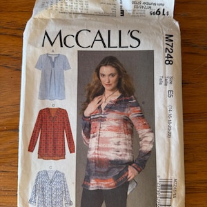 May include: A McCall's sewing pattern envelope, M7248, featuring illustrations of three different blouse designs. The envelope displays a woman wearing a long-sleeved blouse. The pattern includes sizes 14-16-18-20-22.