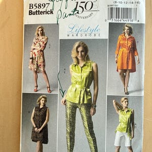 May include: A vintage Butterick sewing pattern, B5897, featuring a Lifestyle Wardrobe collection. The pattern includes designs for various women's clothing items, including dresses, tops, and pants. The pattern celebrates the 150th anniversary.