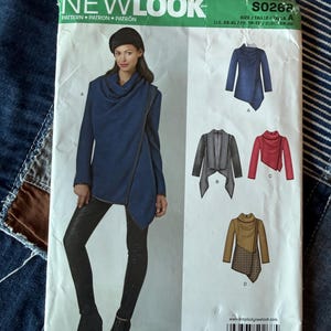 May include: A New Look sewing pattern, S0268, featuring a woman modeling a blue asymmetrical jacket. The pattern includes multiple views of the jacket in different colors and styles. The text "NEW LOOK" is at the top.