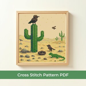 May include: A framed cross-stitch pattern depicting a desert scene with a green cactus, birds, and a lizard. The background is a light tan color, and the text "Cross Stitch Pattern PDF" is at the bottom.