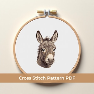 May include: A cross-stitch pattern depicting a donkey's head, with brown and grey fur and a white muzzle. The design is displayed in a wooden embroidery hoop. The text at the bottom reads "Cross Stitch Pattern PDF". The hoop is a classic circular shape.