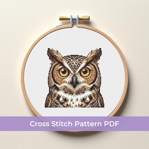 May include: A cross-stitch pattern of an owl with detailed brown and tan feathers, large yellow eyes, and a white chest. The design is displayed in a wooden embroidery hoop. Text at the bottom reads "Cross Stitch Pattern PDF."