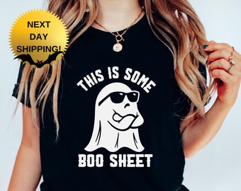 May include: Black t-shirt with a white ghost wearing sunglasses and the text "This is some boo sheet".