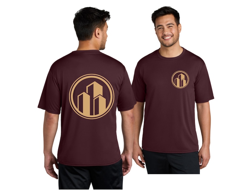May include: Maroon short-sleeve t-shirt with a gold circular logo featuring three stylized buildings. The logo is repeated on the front and back of the shirt. The shirt is worn by a person.