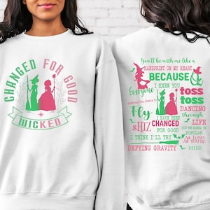 May include: White sweatshirt with a green and pink graphic print of two witches and the text "Changed for Good Wicked". The back of the sweatshirt has a green and pink graphic print with the text "You'll be with me like a handprint on my heart because I knew you everyone deserved the chance to fly shiz changed for good I think I'll try defying gravity toss toss dancing through life you're gonna be popular as long as you're mine."