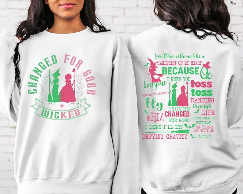 May include: White sweatshirt with a green and pink graphic print of two witches and the text "Changed for Good Wicked". The back of the sweatshirt has a green and pink graphic print with the text "You'll be with me like a handprint on my heart because I knew you everyone deserved the chance to fly shiz changed for good I think I'll try defying gravity toss toss dancing through life you're gonna be popular as long as you're mine."