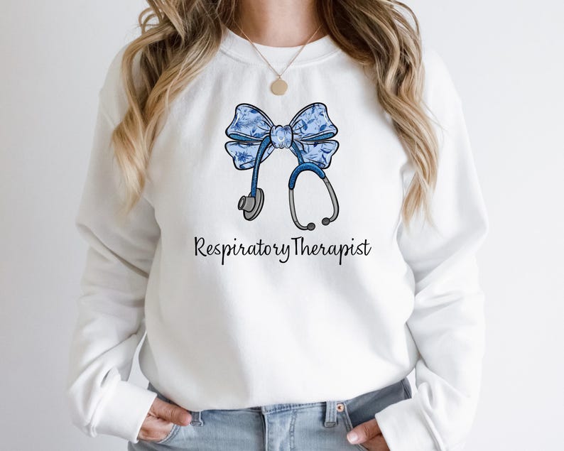 May include: White sweatshirt with a blue and white floral bow and a stethoscope, with the text "Respiratory Therapist" printed below.