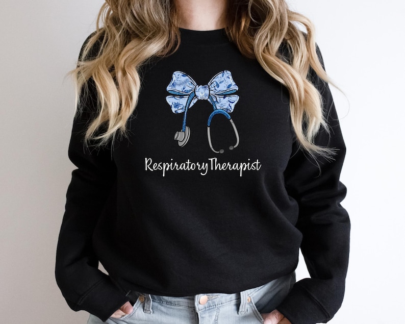 May include: Black sweatshirt with a blue and white bow and a stethoscope, with the text "Respiratory Therapist" printed below.