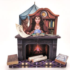May include: A paper diorama depicting a fortune teller. A woman in a red hood is seated behind a table with a crystal ball, tarot cards, and a scroll. A fireplace, bookshelf, and books are also present.